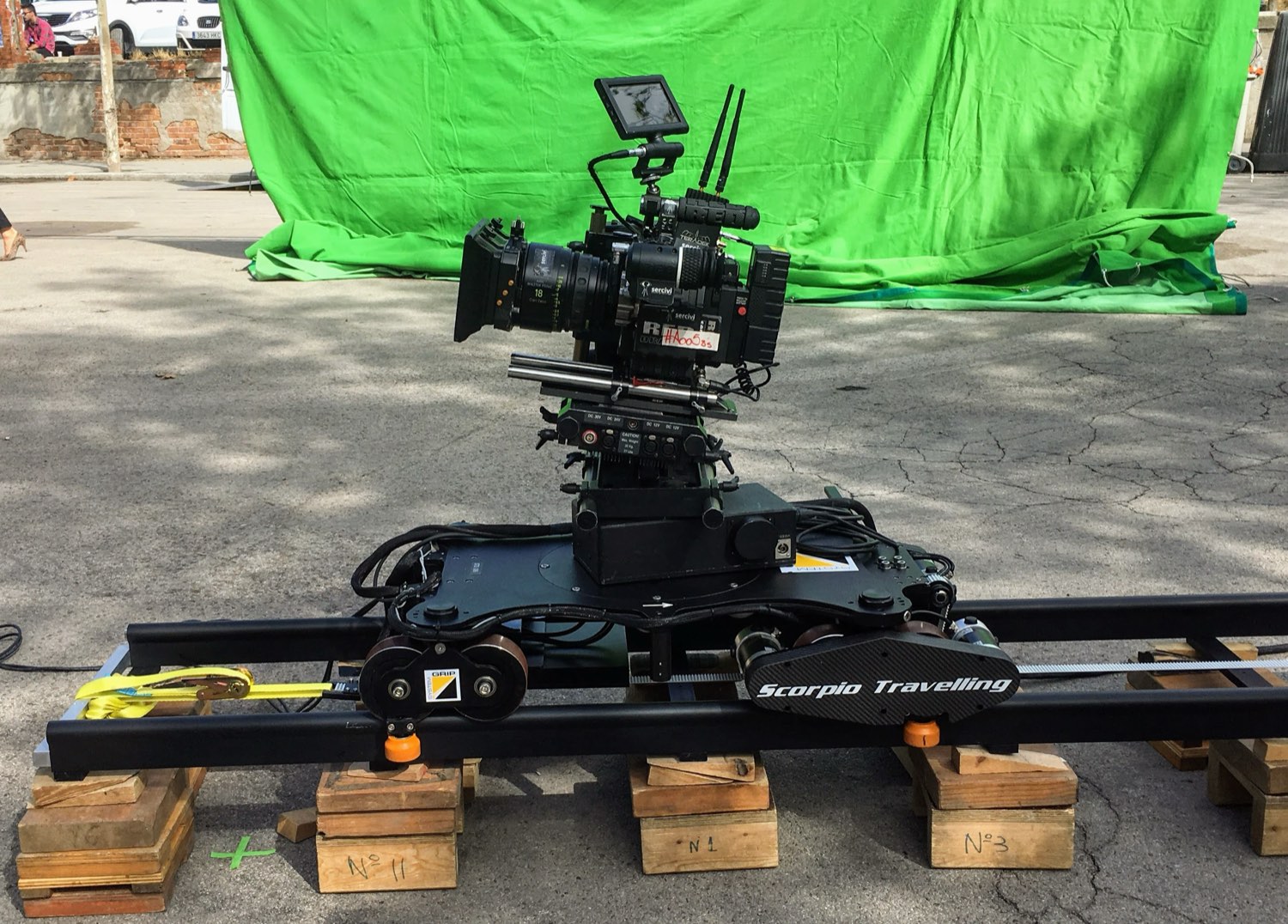 Cinema camera on a Scorpio dolly on track in front of a green screen